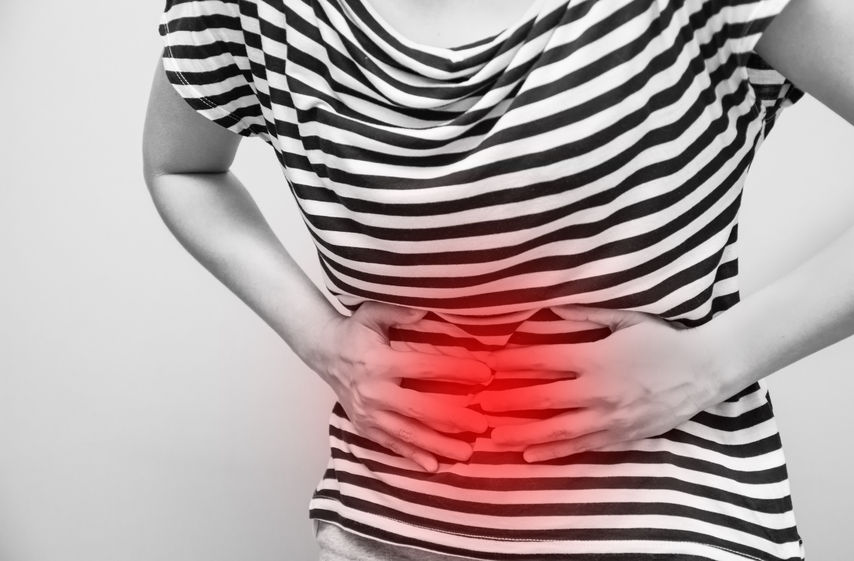 young woman having abdominal pain, upset stomach or menstrual cramps